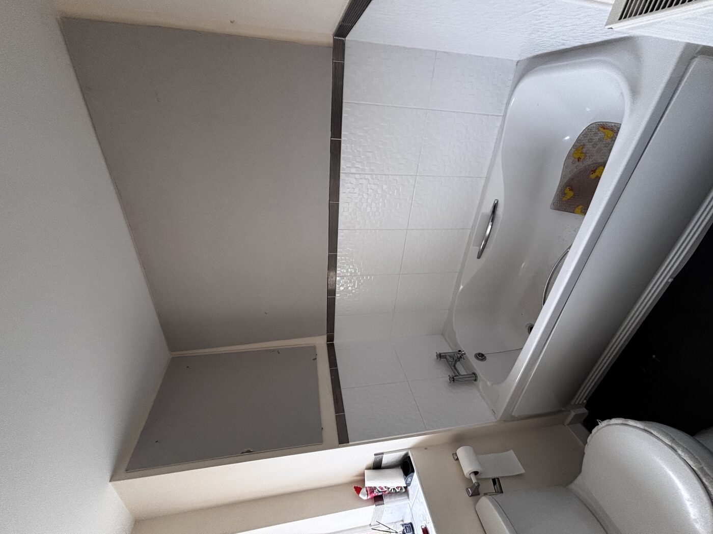 Original bathroom — bath only, painted walls, no shower