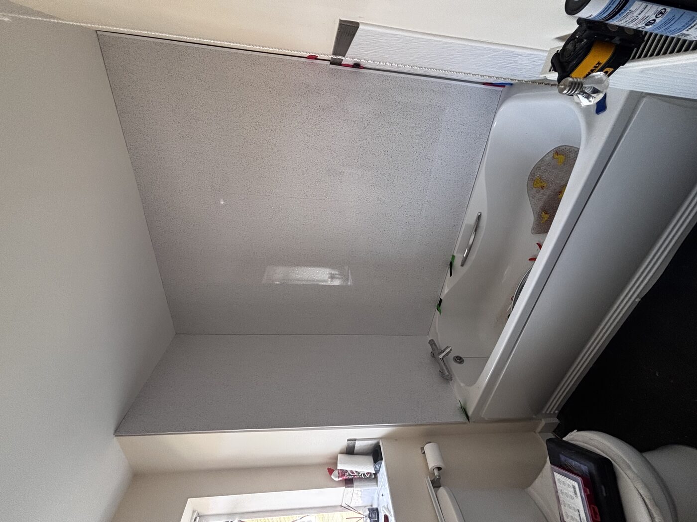 Panels bonded to walls — seamless finish, no grout lines