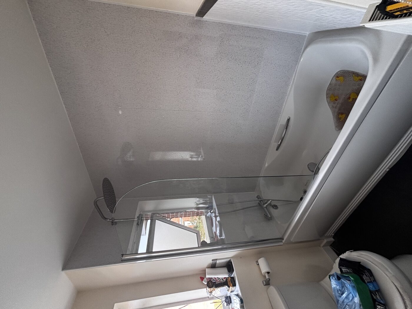 Finished — bath screen fitted, shower rail and rainfall head installed