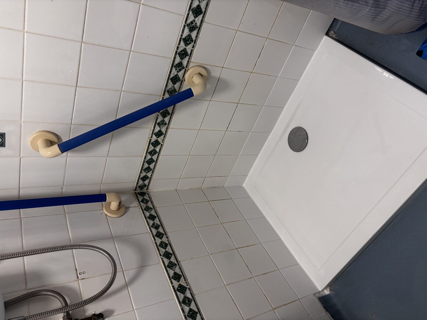 New shower tray fitted over the existing wetroom floor — connected directly to the waste