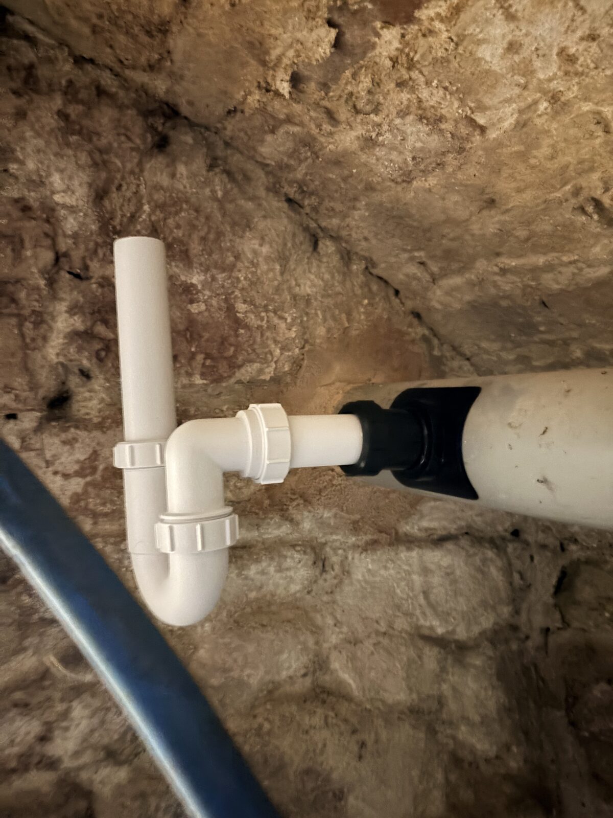 Installed waste standpipe and P-trap connected to the existing waste pipe