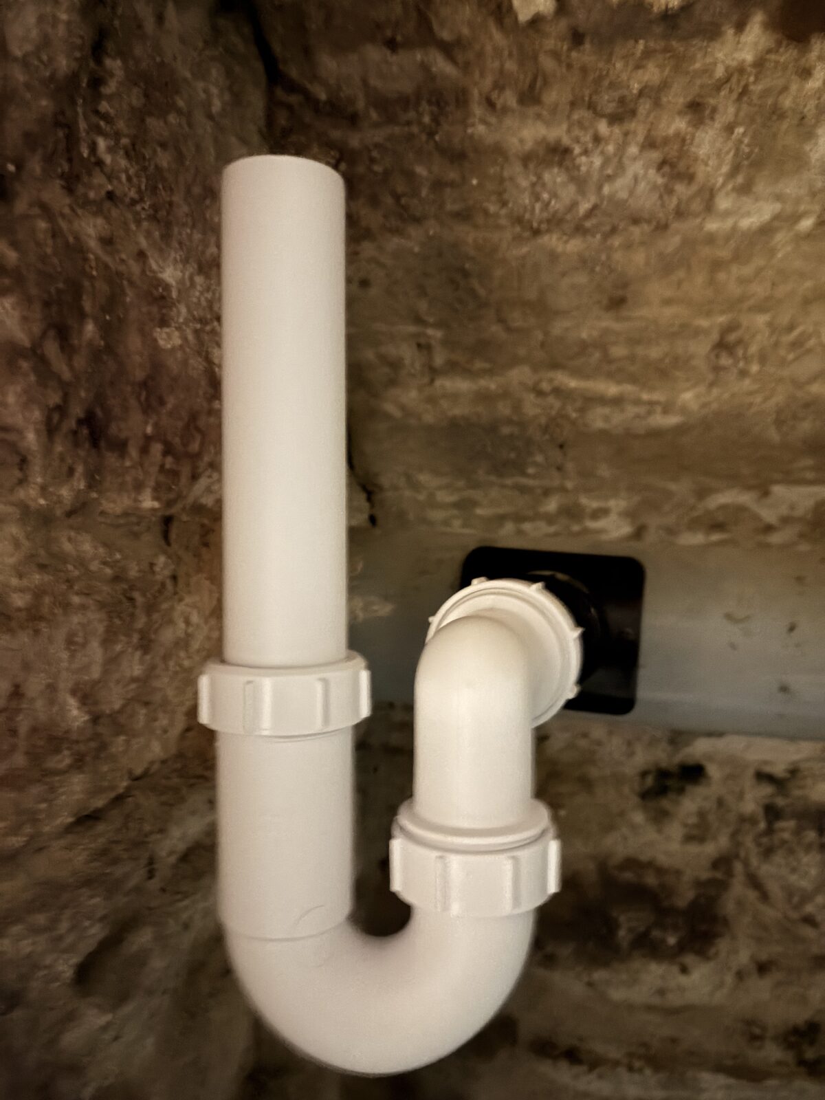 Close-up of the fitted P-trap and standpipe for the permanent dehumidifier drain