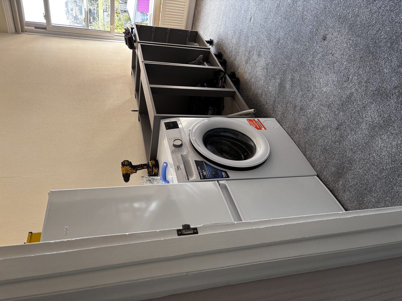 Carcasses being assembled and positioned — fridge freezer and washing machine in place