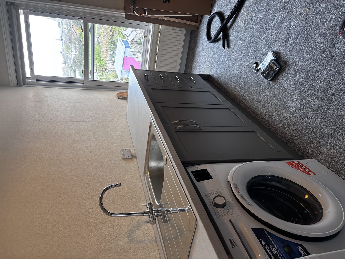 Full view of the finished kitchen — everything plumbed, wired, and working
