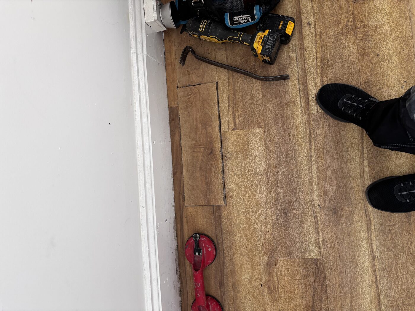 Floorboard section lifted to access the pipework below