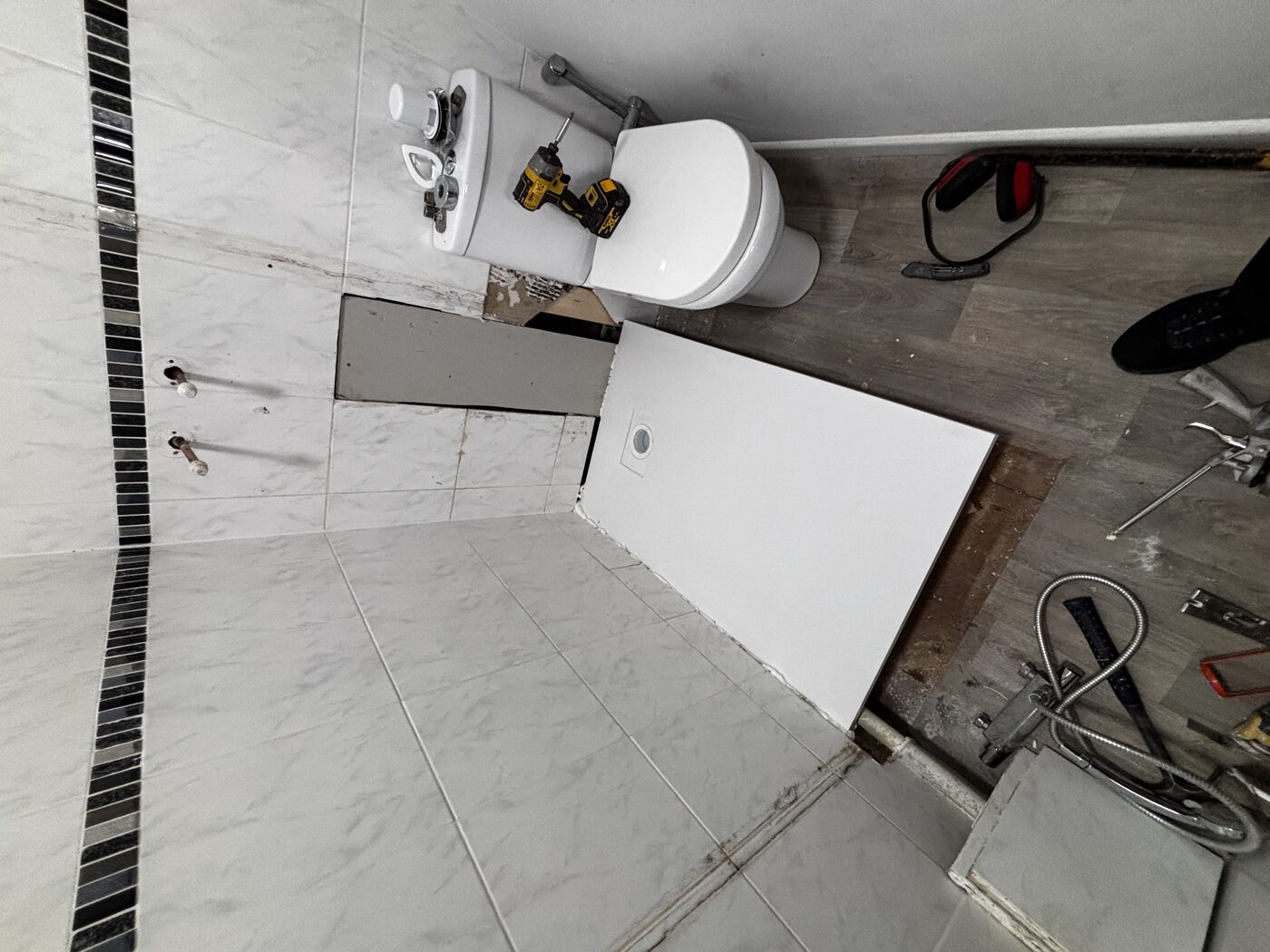 New shower tray positioned, access panel still open