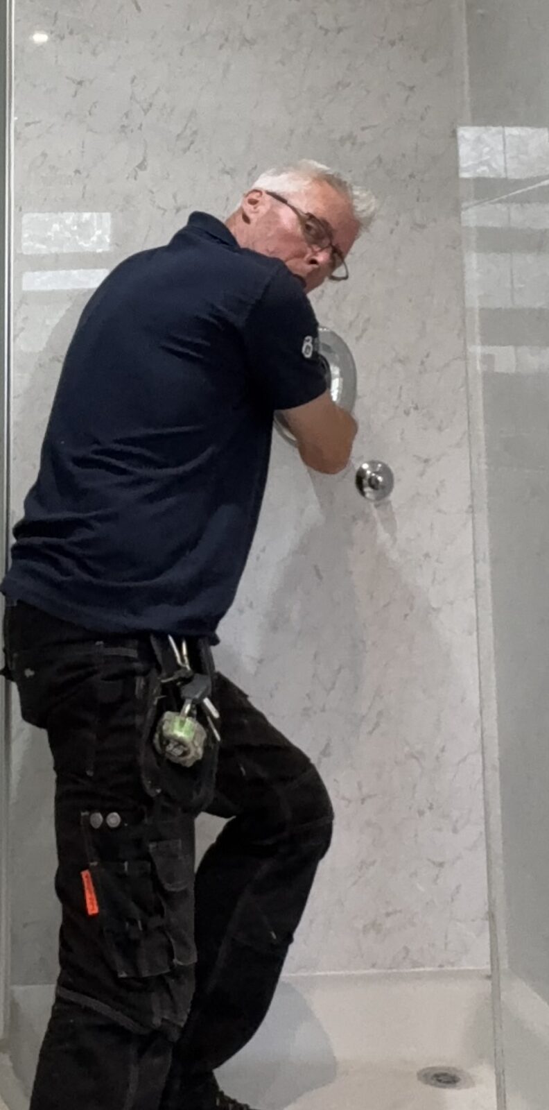 Close-up of Steve working on the Ryde shower-panel installation