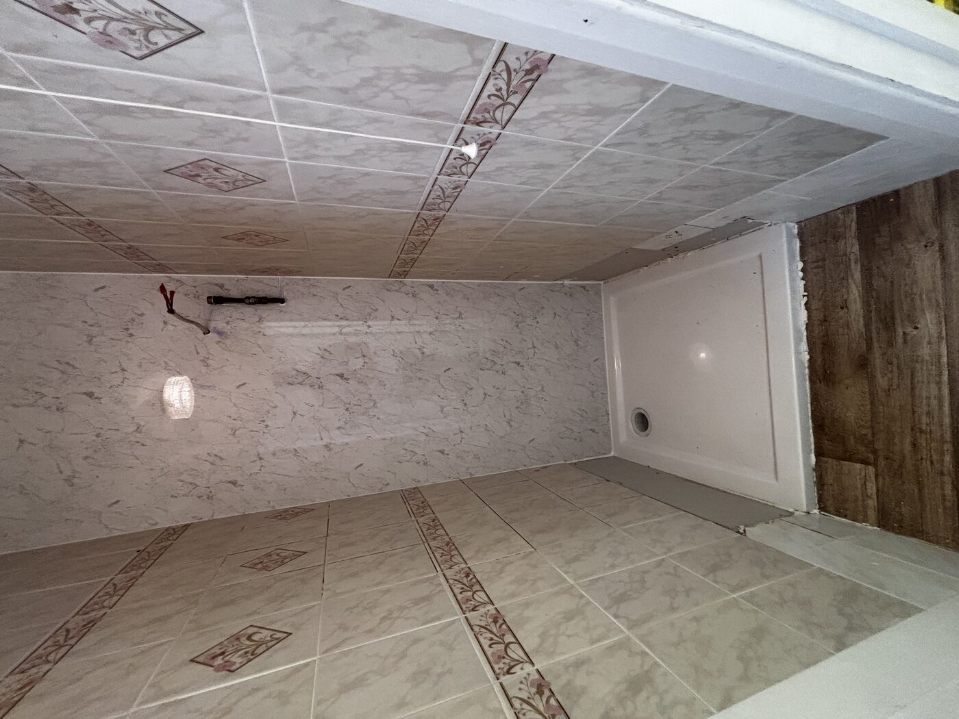 Subfloor rebuilt, new shower tray seated and levelled