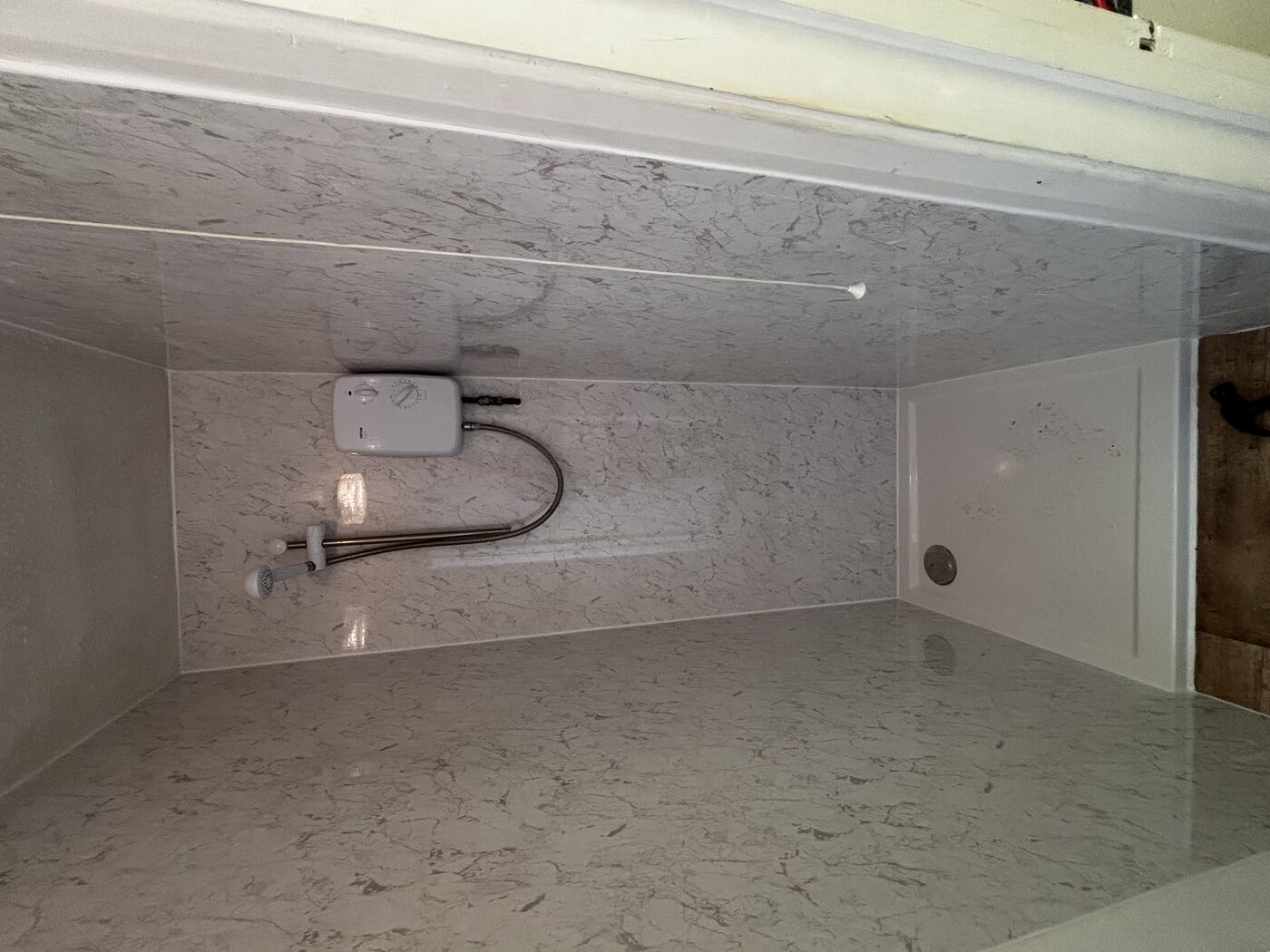 Finished — new electric shower, full aqua panel surround, clean modern look
