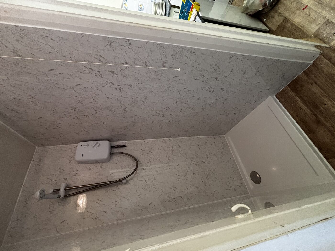 Side view — panels fitted seamlessly to all walls, new tray and drain cover