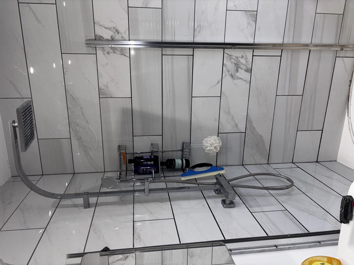 Existing shower — marble tiles and rainfall head, but tray seal had failed