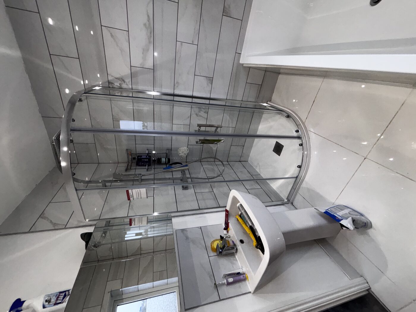 Finished bathroom — new enclosure fitted neatly alongside existing basin and bath