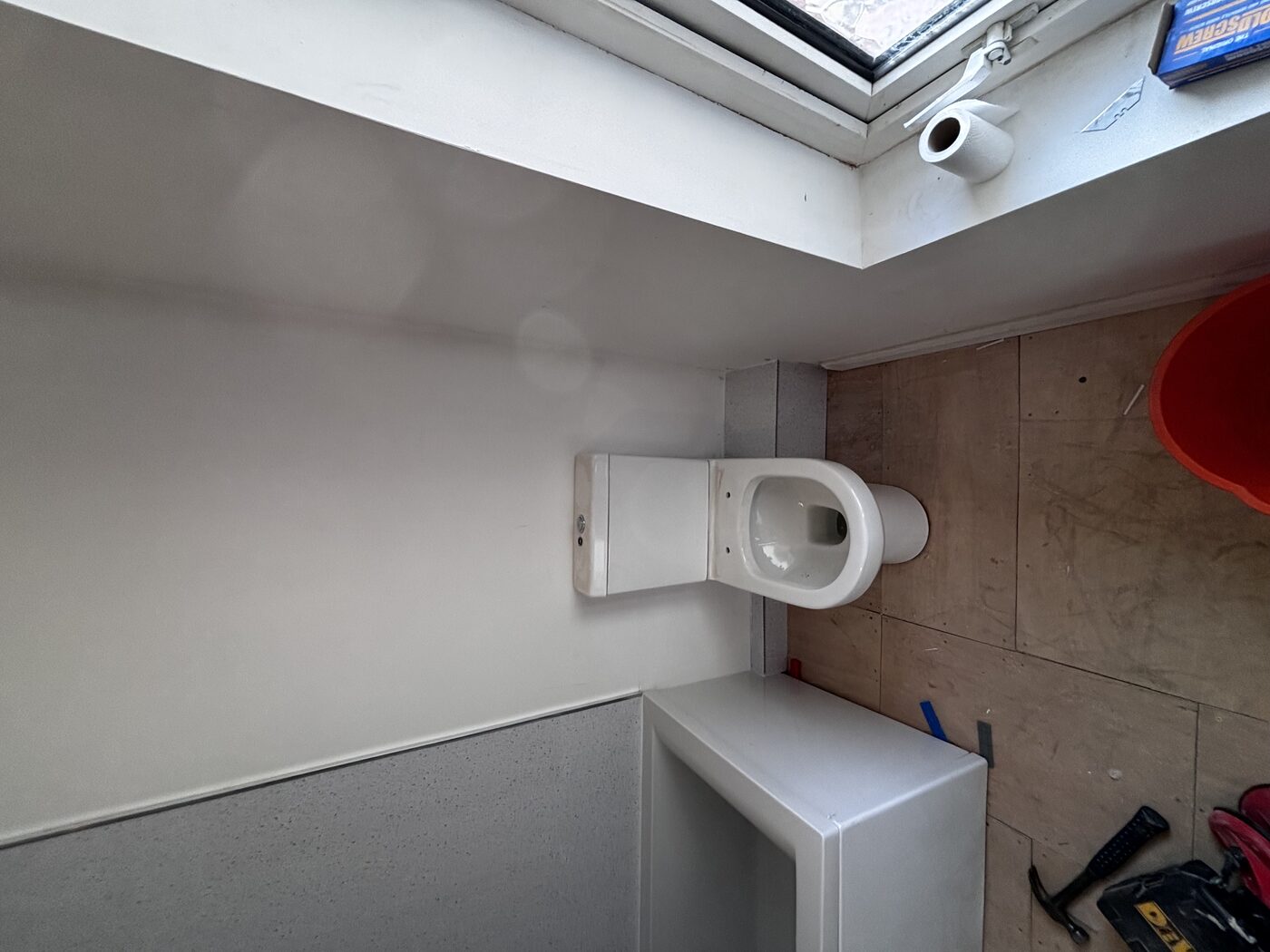 Bath panel fitted, toilet back in — room ready for finishing
